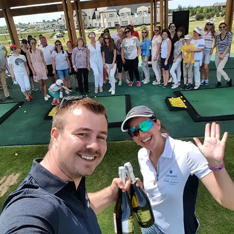 Group raising prosecco on the range